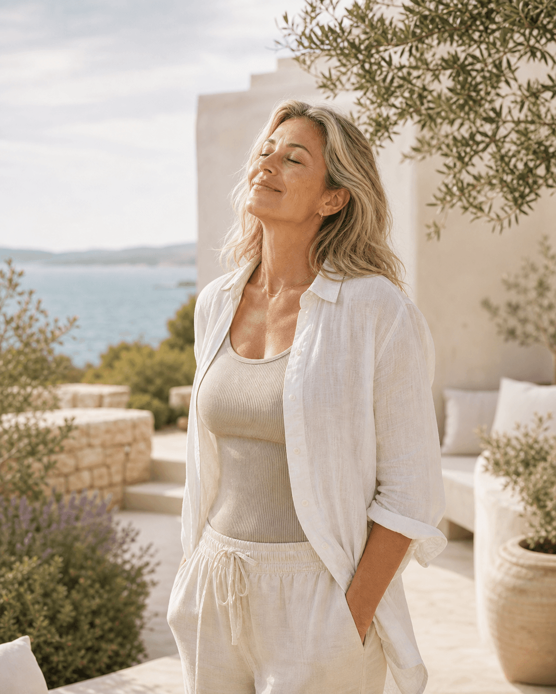 Woman enjoying morning sunlight on a coastal garden terrace